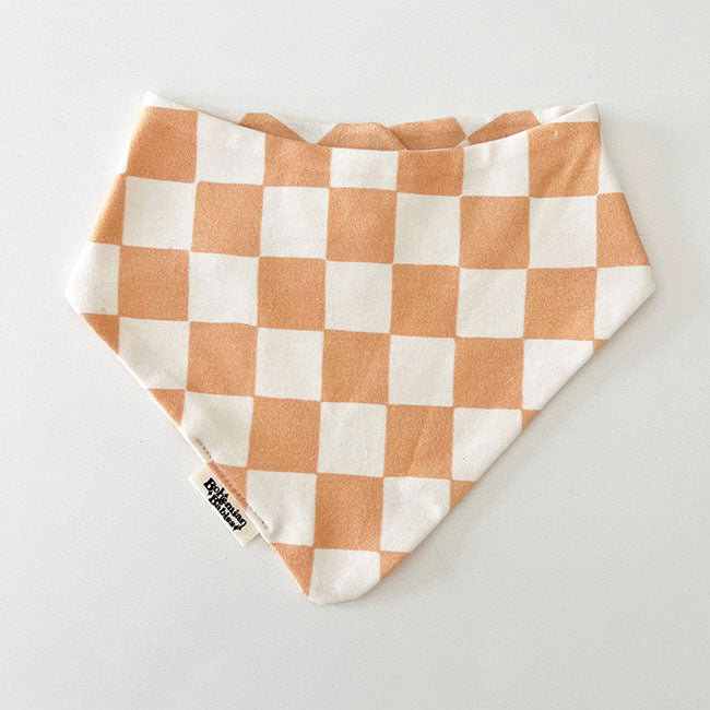 Bohemian Babies made in the USA organic cotton bandana bib. Snap closure. Rose Pinkcheckered print. dusty rose checkers on an off-white background. Front view.