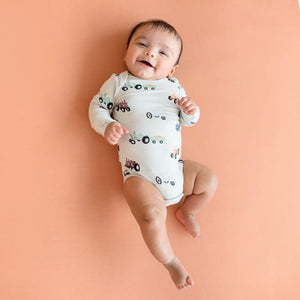 Kyte Baby Printed Long Sleeve Bodysuit in Tractor